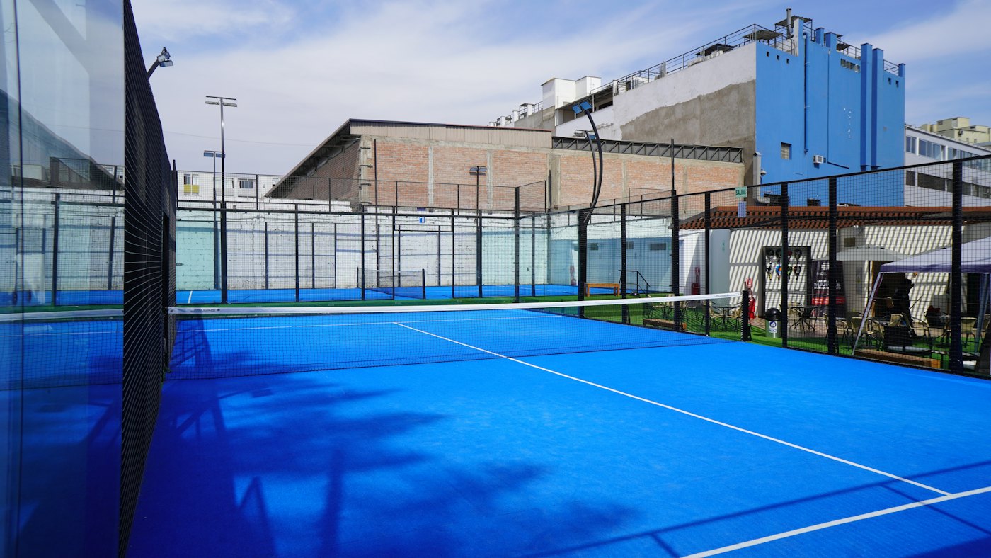A wide view of a blue padel court